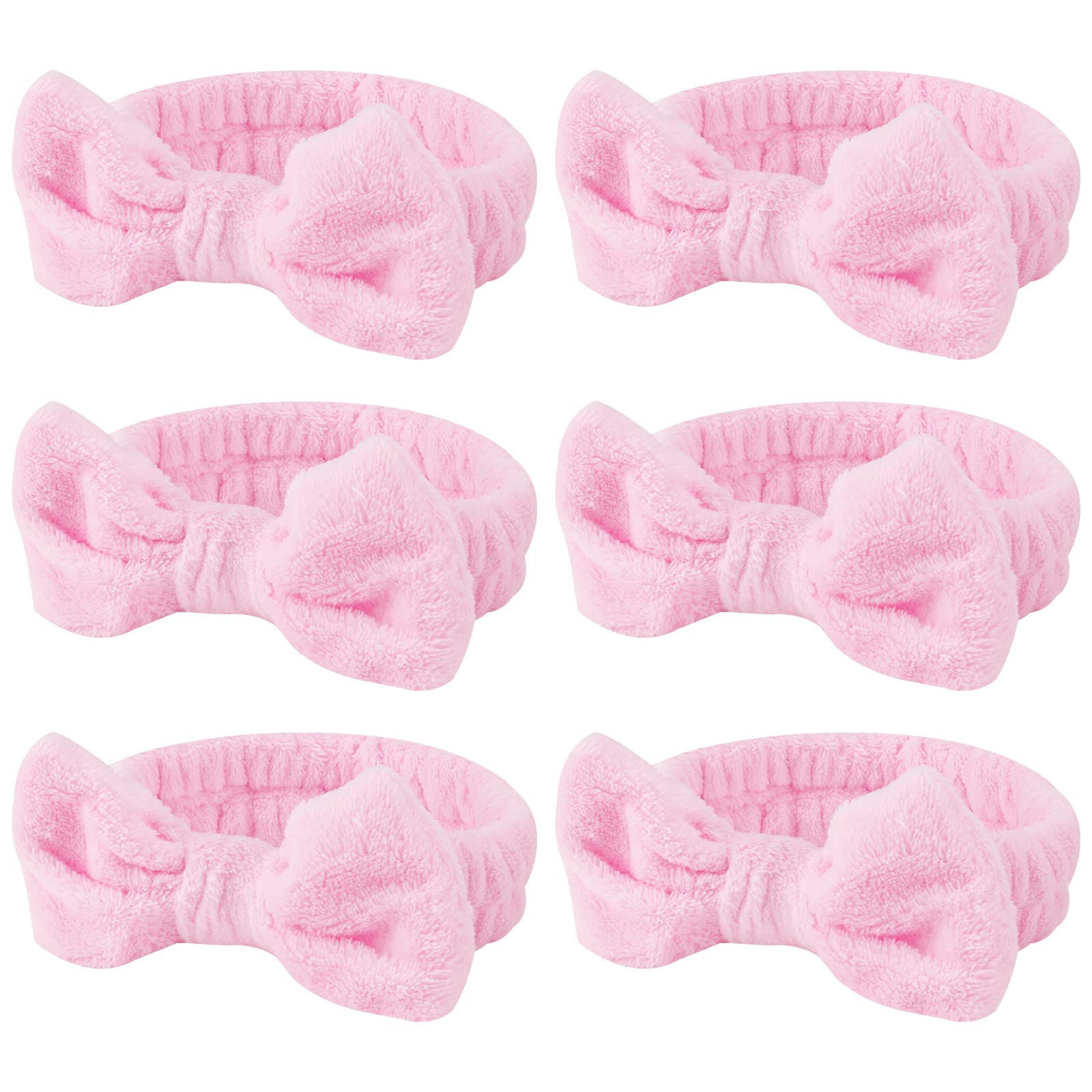 Casoty pink spa headband with bow keeps hair away during skincare.
