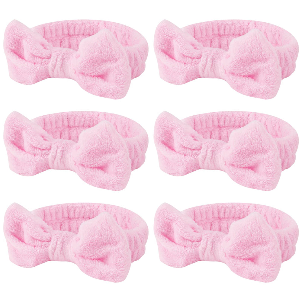 Casoty pink spa headband with bow keeps hair away during skincare.