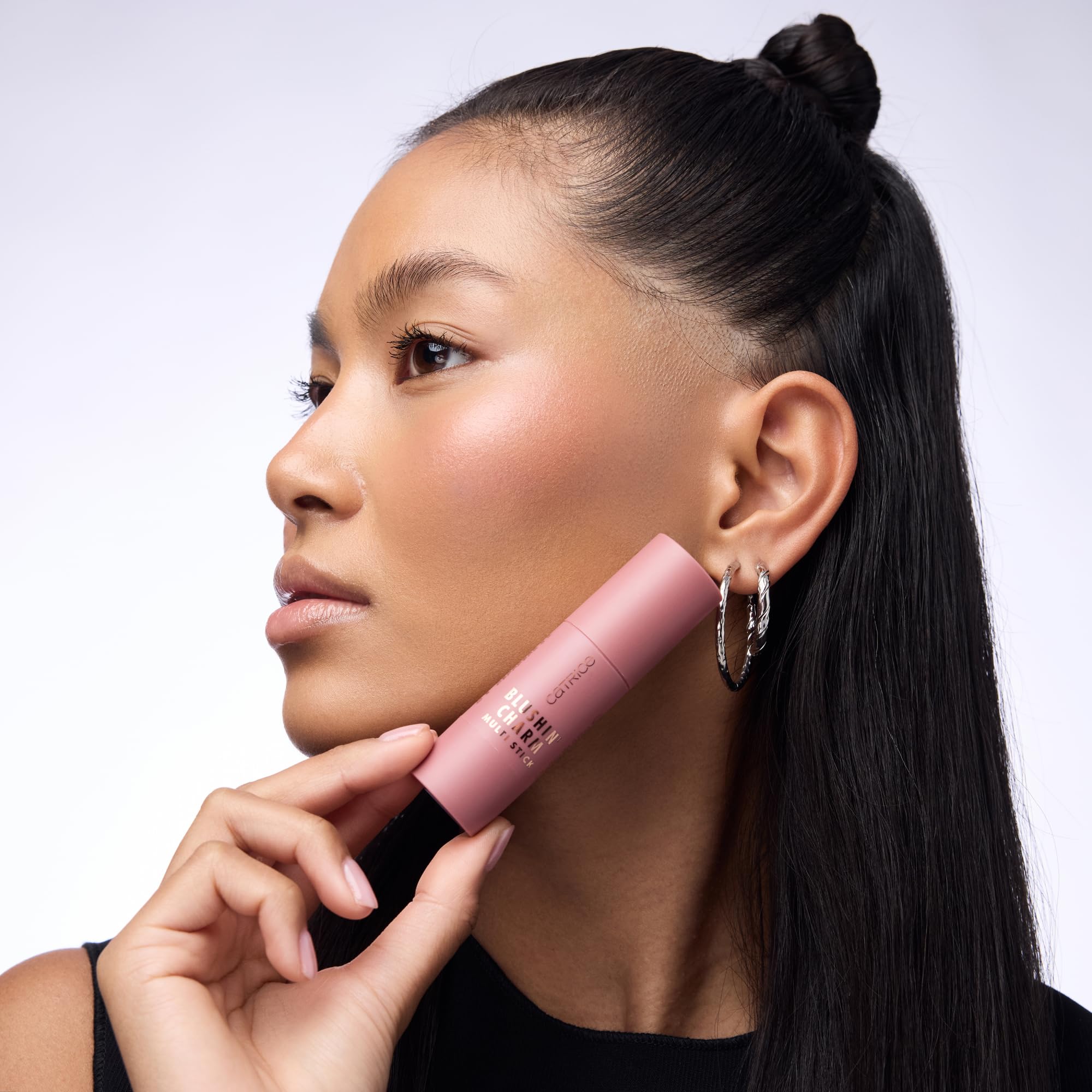 On-the-go use of Blushin' Charm Multi Stick in a makeup bag scene