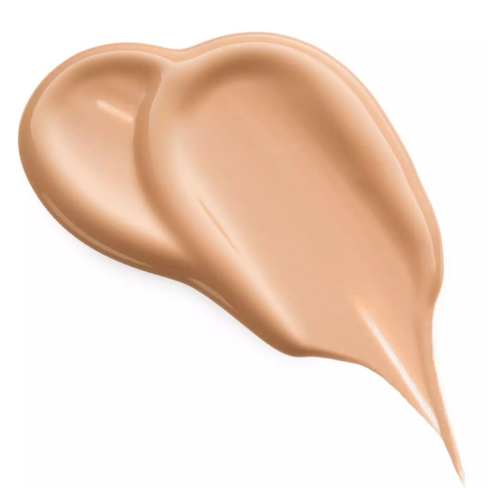 Close-up of applicator applying concealer for smooth texture