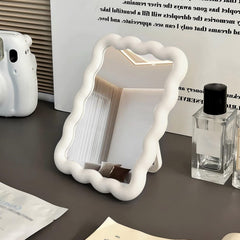 CCREDONE wave-shaped makeup mirror on a desk with a clear, true reflection