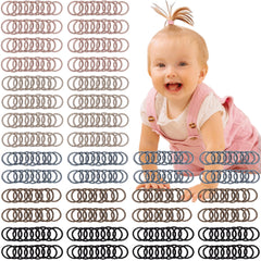 CÉLLOT brown baby hair ties close-up, gentle hold for toddlers.
