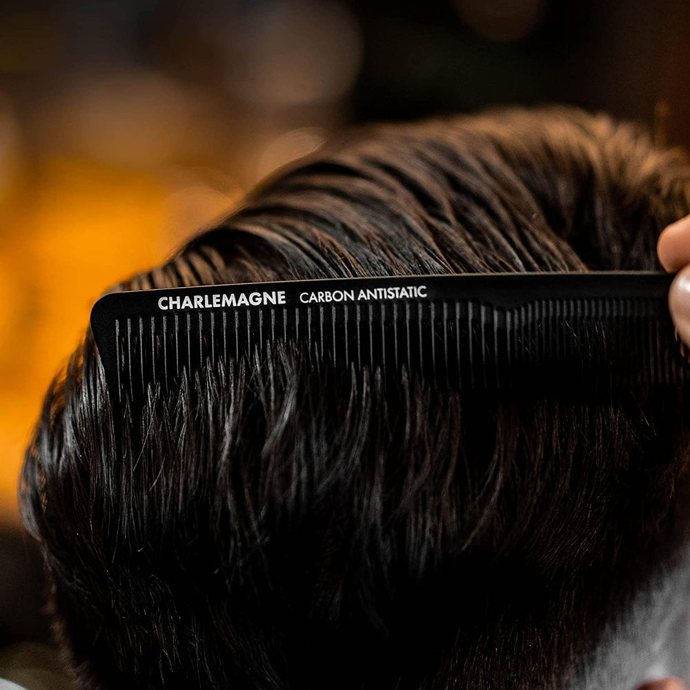 Charlemagne portable hair comb slipped into a pocket for on-the-go grooming.