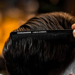 Charlemagne portable hair comb slipped into a pocket for on-the-go grooming.