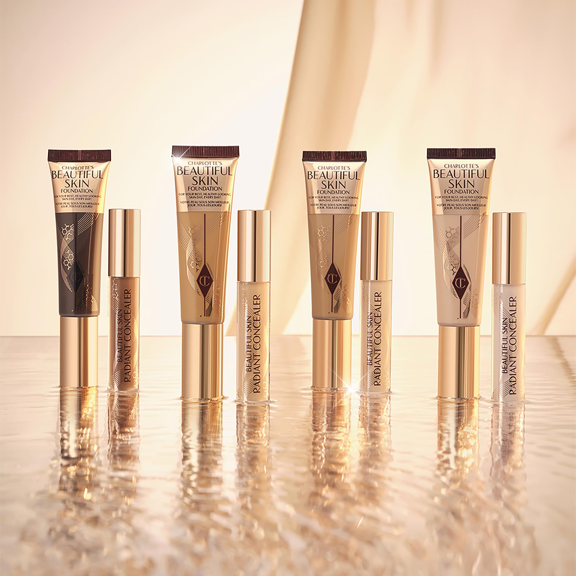 Charlotte Tilbury Beautiful Skin Foundation bottle held between hands for skincare-inspired makeup.