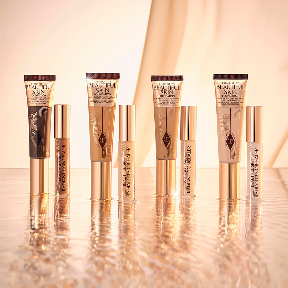 Charlotte Tilbury Beautiful Skin Foundation bottle held between hands for skincare-inspired makeup.