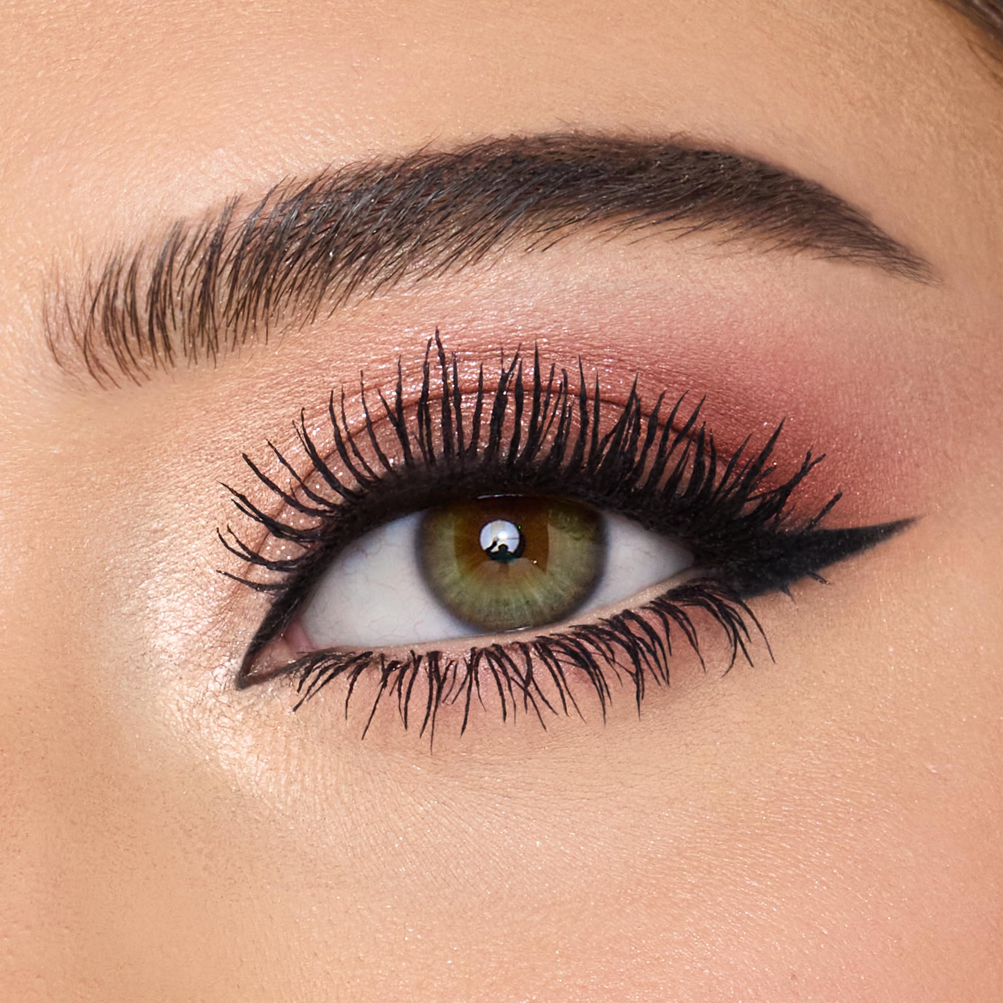 Charlotte Tilbury Exagger-Eyes transparent sparkle shade adds center lid sparkle for emphasis.
