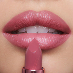 Mini lipsticks arranged in the trio demonstrate portable, leak-free travel packaging.