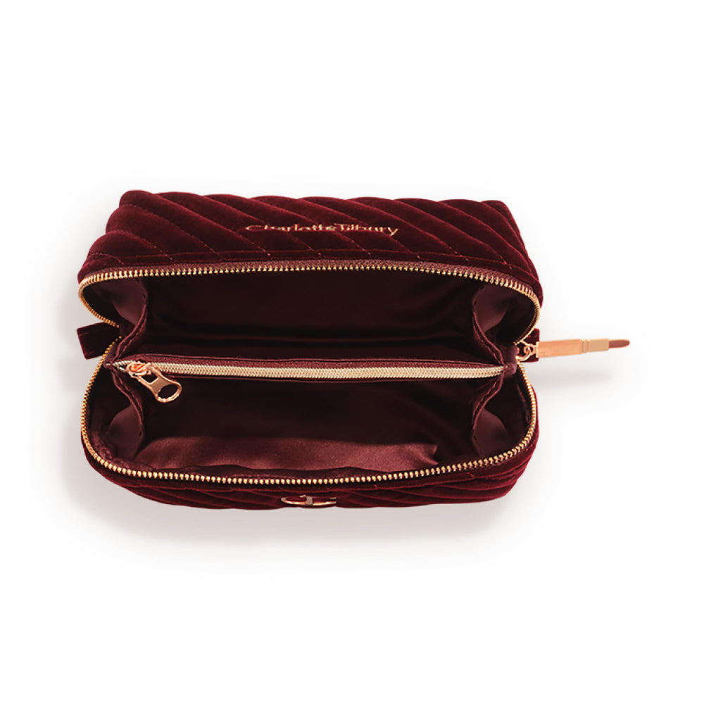 Charlotte Tilbury makeup bag with two compartments and zip pocket keeps cosmetics organized.