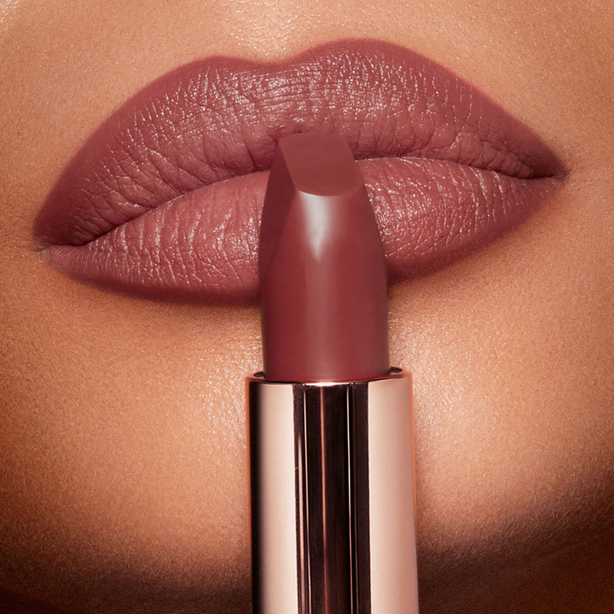 Charlotte Tilbury Pillow Talk Medium close-up showing soft, warm nude-pink hue on lips.