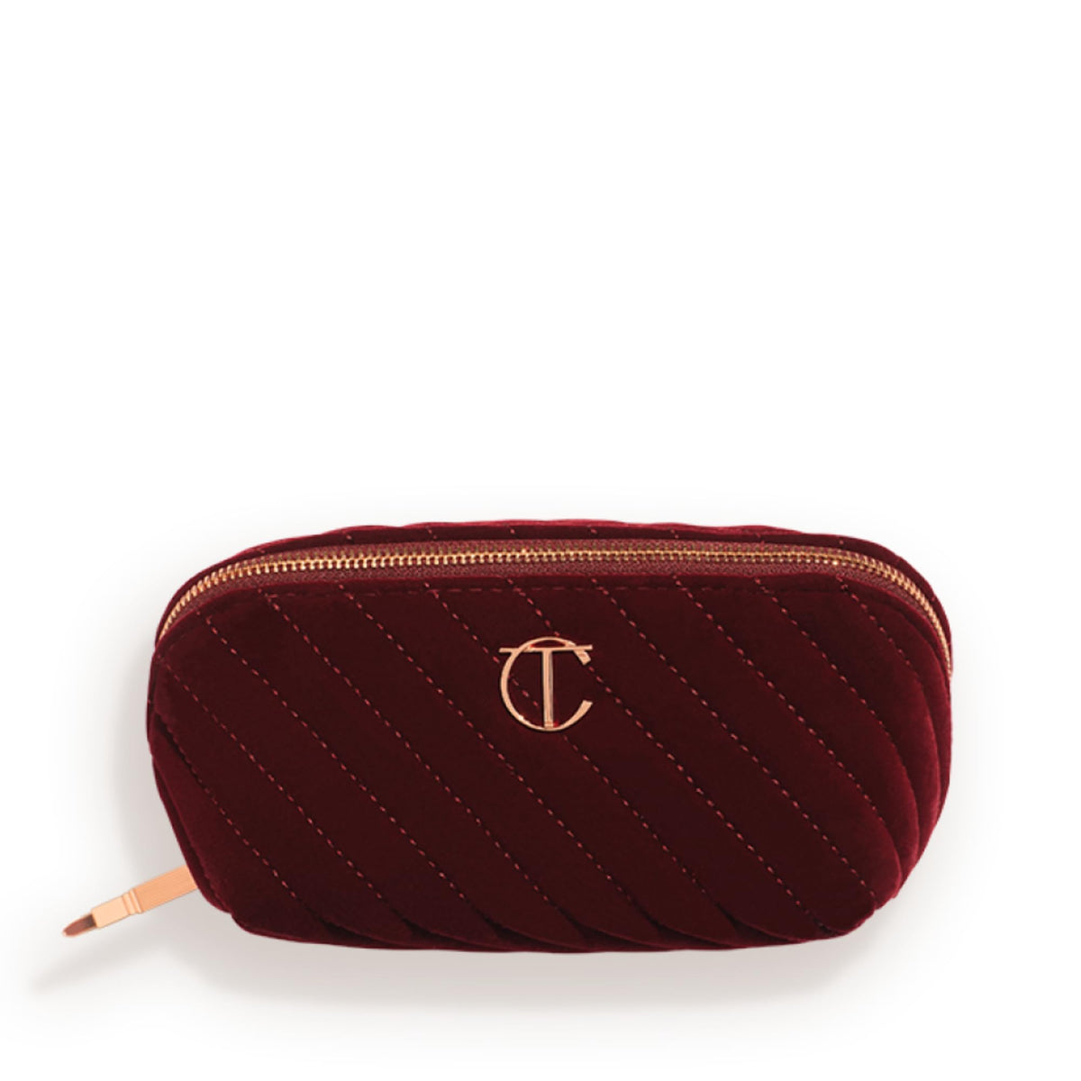 Charlotte Tilbury medium travel makeup bag in quilted velvet with three compartments for organized travel.