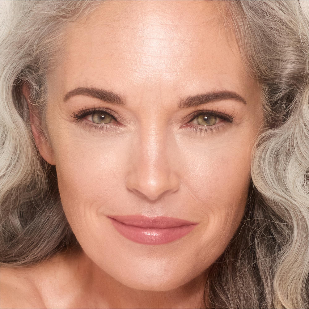 Charlotte Tilbury Unreal Skin Tint glow finish closeup on skin.