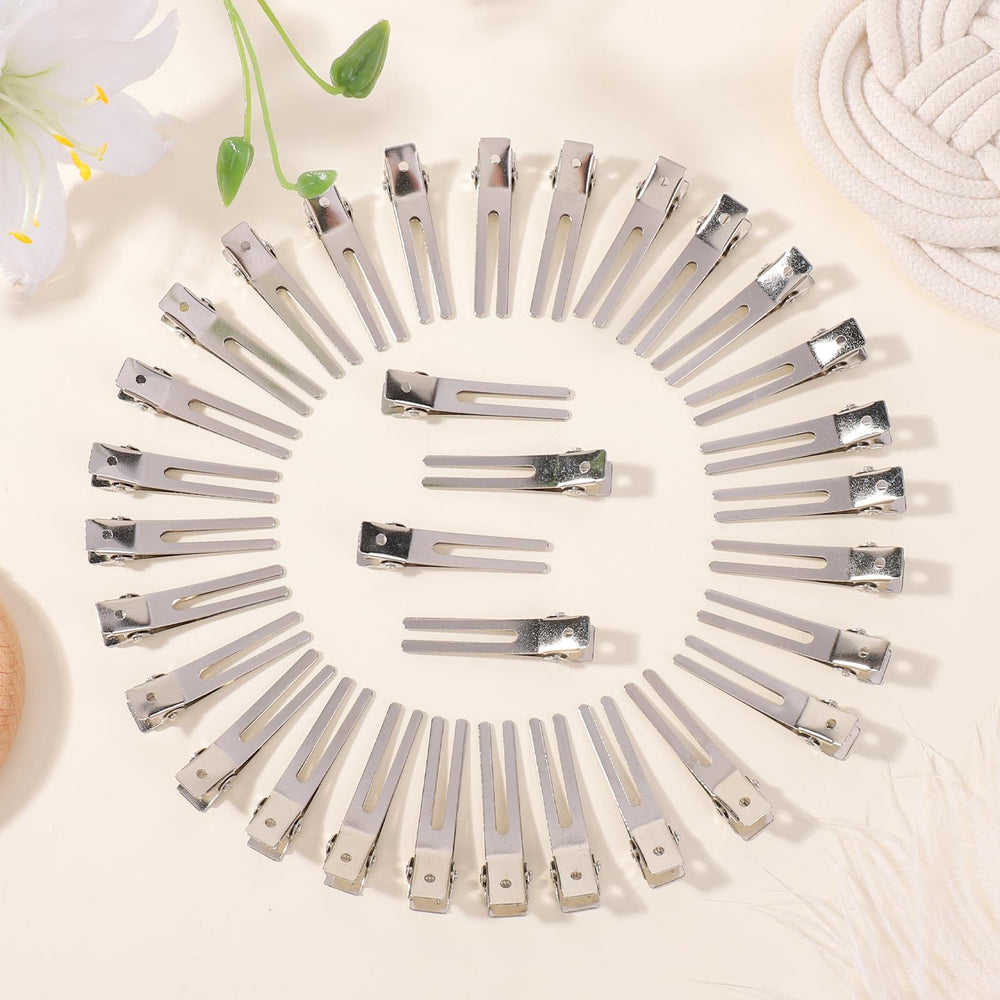 Pinza ChoicBaby de metal plateado con doble diente, sujeción firme para rodillos.