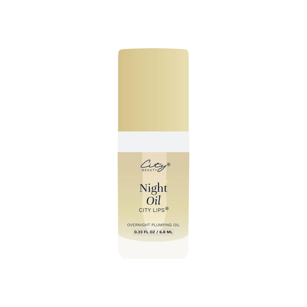 City Beauty City Lips Night Oil beside a softly lit nightstand