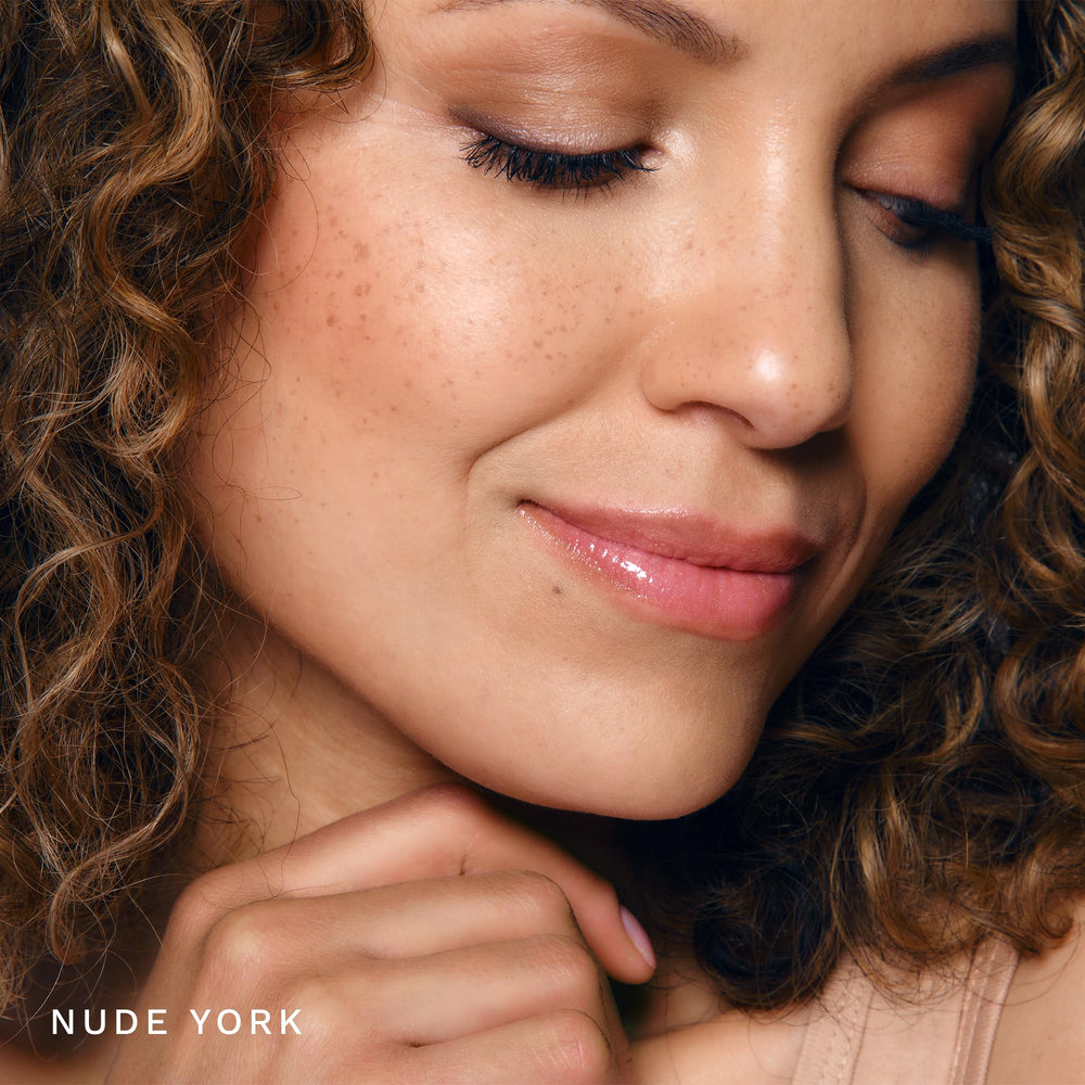Gold-glittery finish of City Lips Nude York gloss catches light.