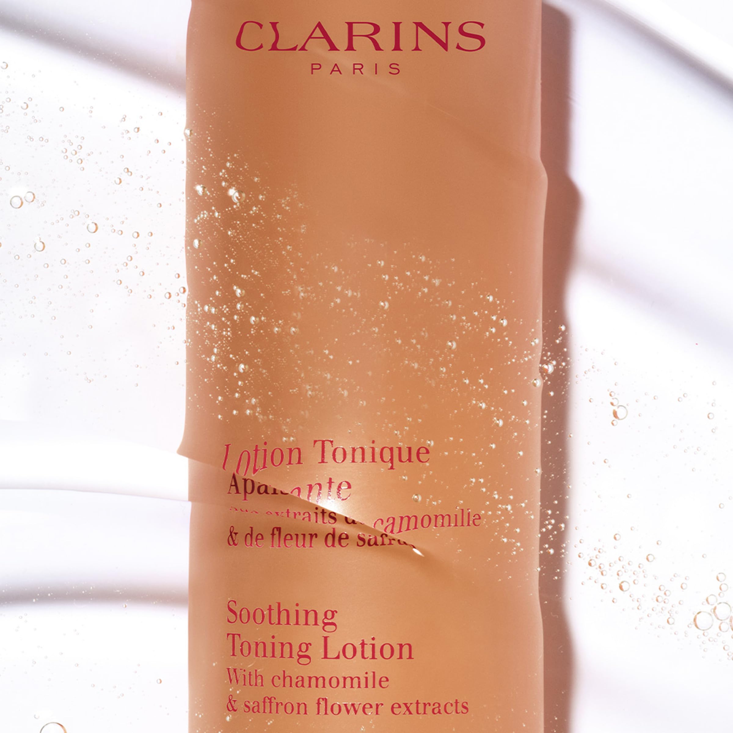 Clarins Soothing Toning Lotion cotton-ball application demonstrates gentle cleansing and balance.