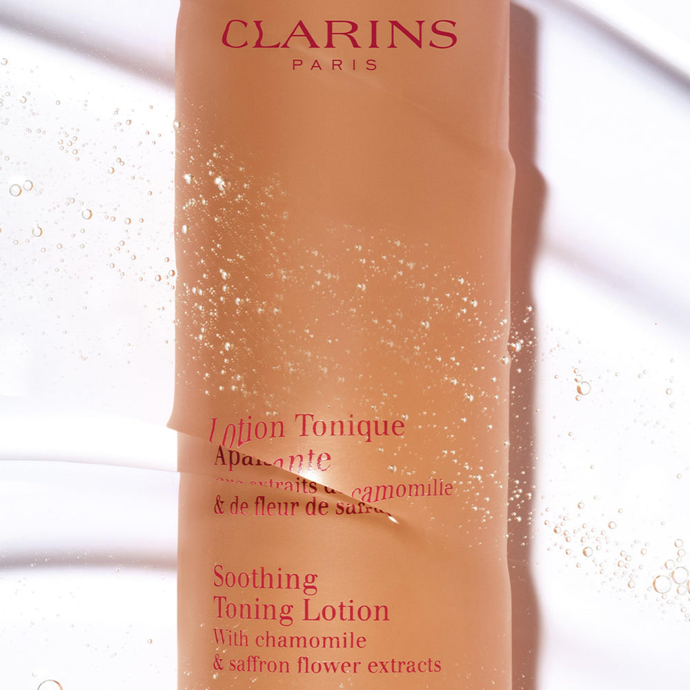 Clarins Soothing Toning Lotion cotton-ball application demonstrates gentle cleansing and balance.