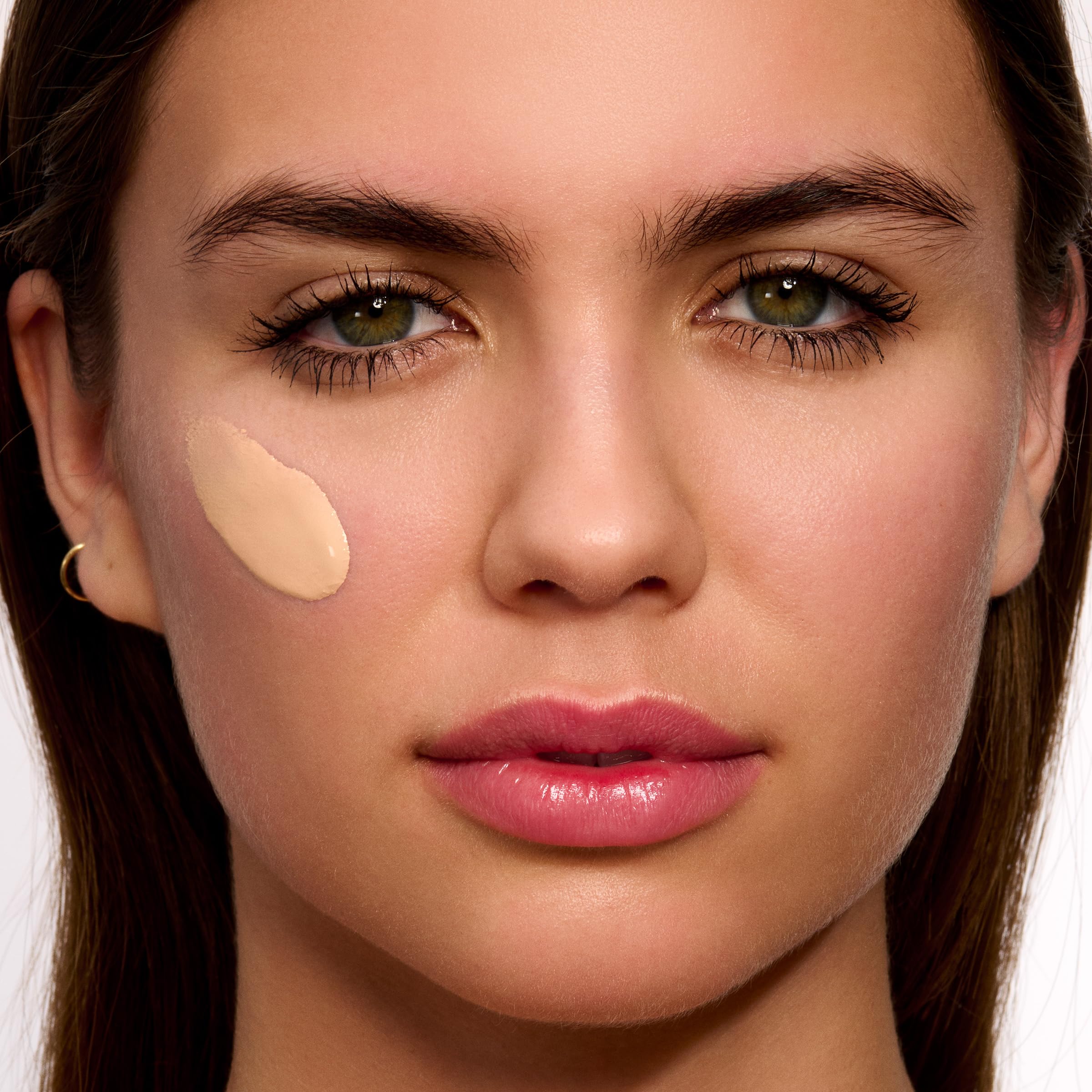 Clarins UV Plus application on palm demonstrating daily use