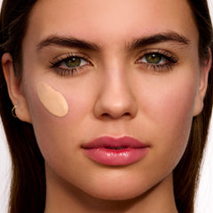 Clarins UV Plus application on palm demonstrating daily use