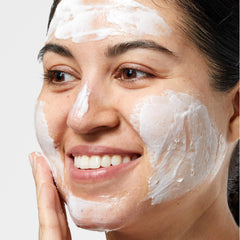 Clinique 7 Day Scrub Cream being applied to face for smoothing makeup.