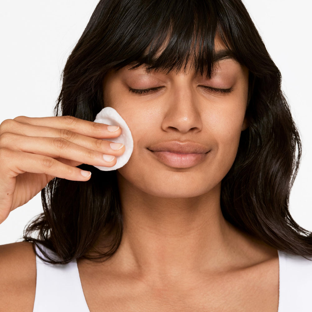 Clinique Clarifying Lotion 1 bottle with cotton ball in use.