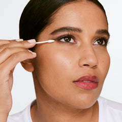 Clinique eye makeup remover cotton pad application for precise spot cleaning.