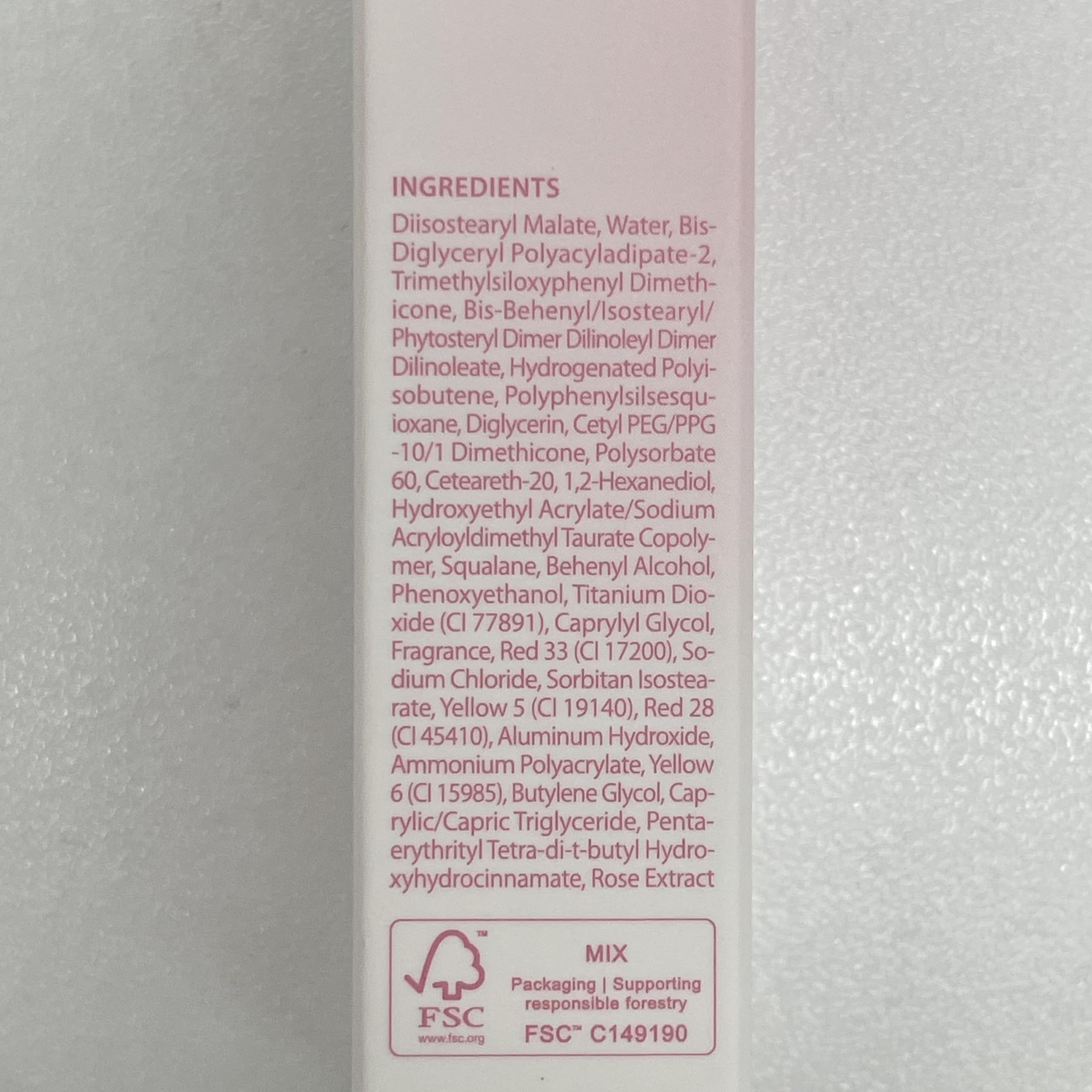 CLIO PROFESSIONAL size comparison next to coin illustrating compact travel-friendly tube
