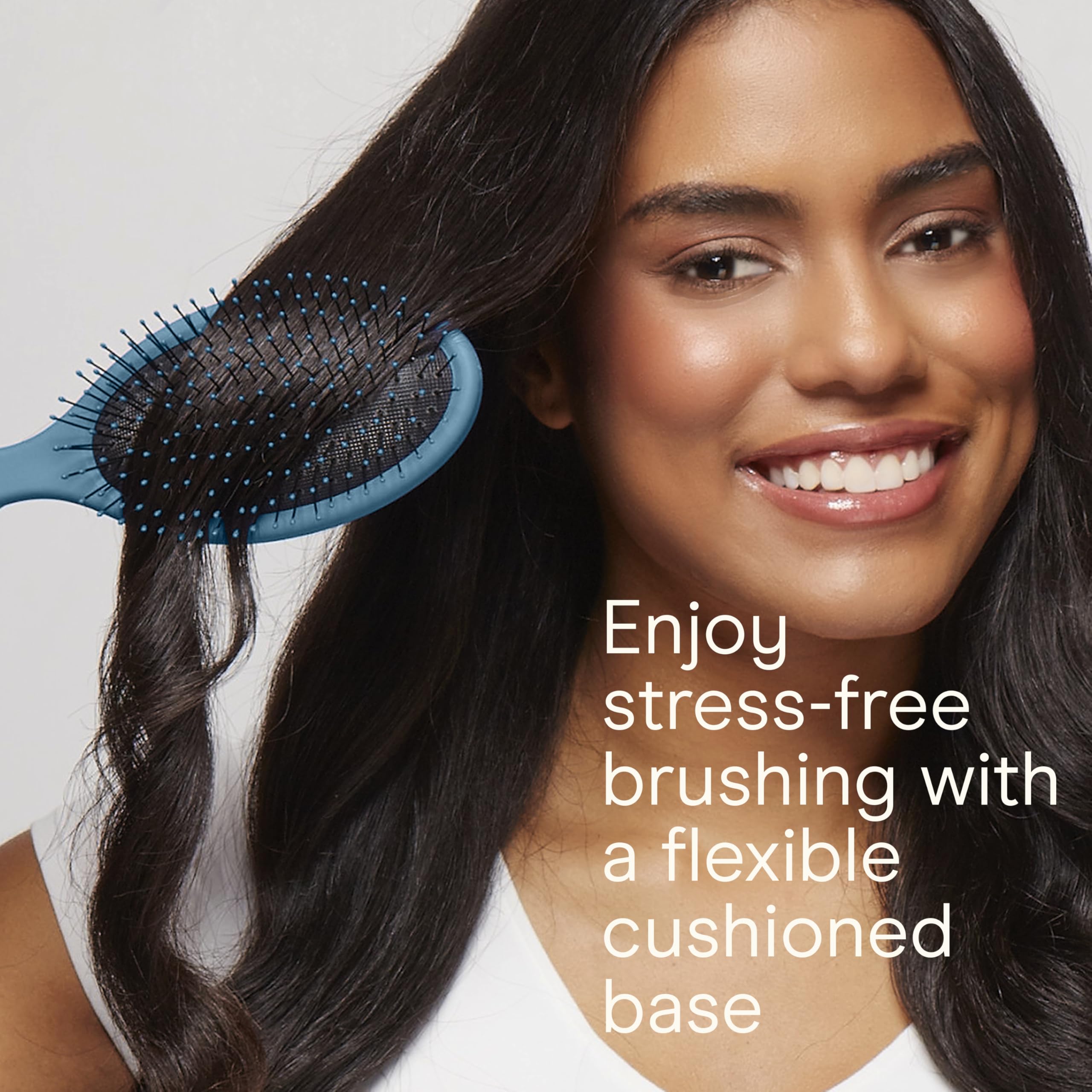 Close-up of Conair detangling brush showing soft ball-tipped bristles for gentle detangling.