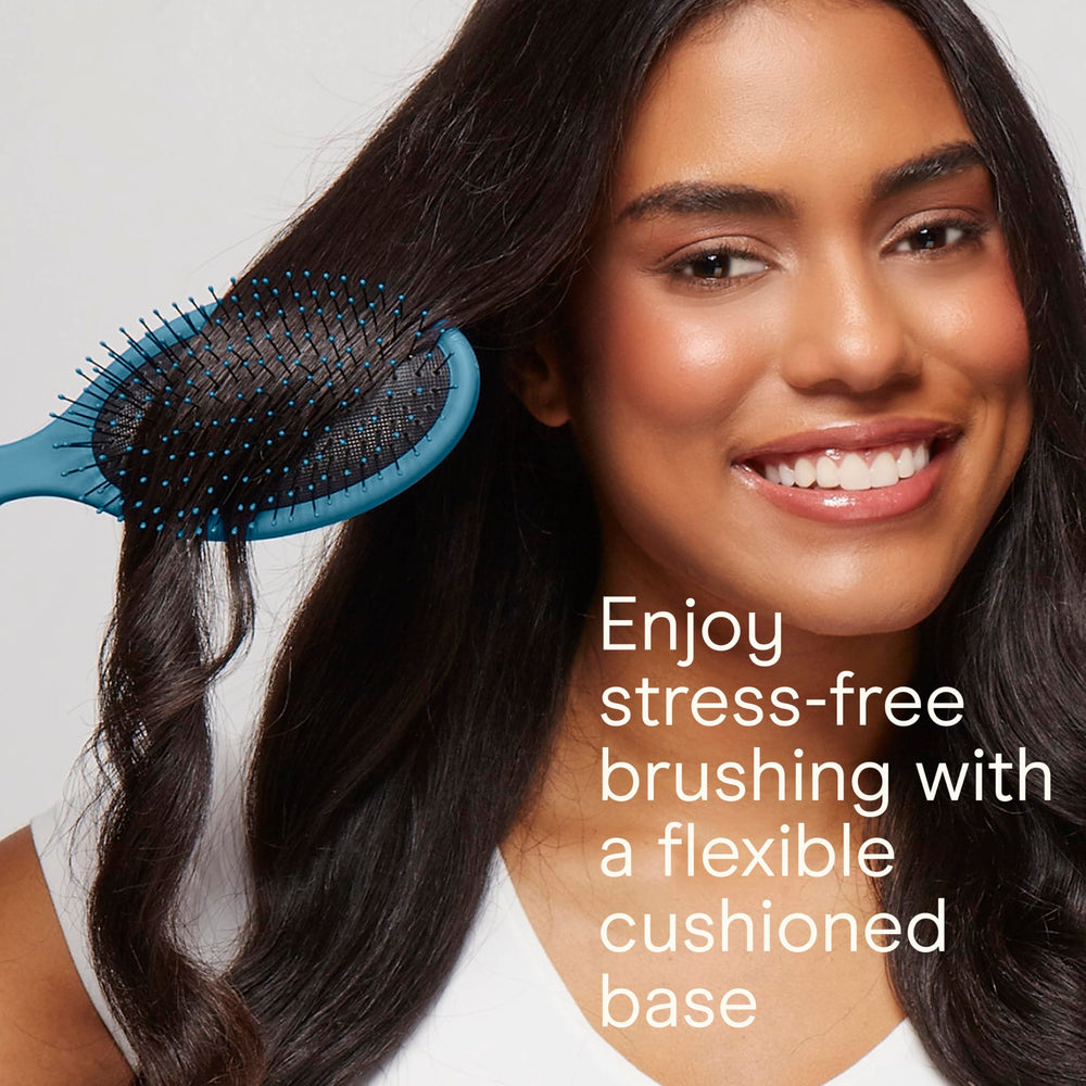 Close-up of Conair detangling brush showing soft ball-tipped bristles for gentle detangling.
