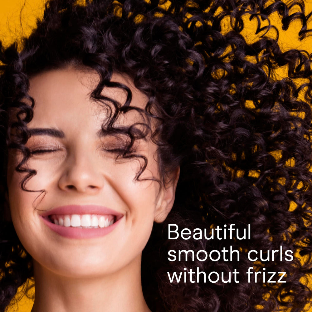 Conair curling iron showing dual voltage, ideal for travel styling.