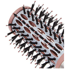 User holds brush with nylon and ball-tipped bristles for comfortable control.