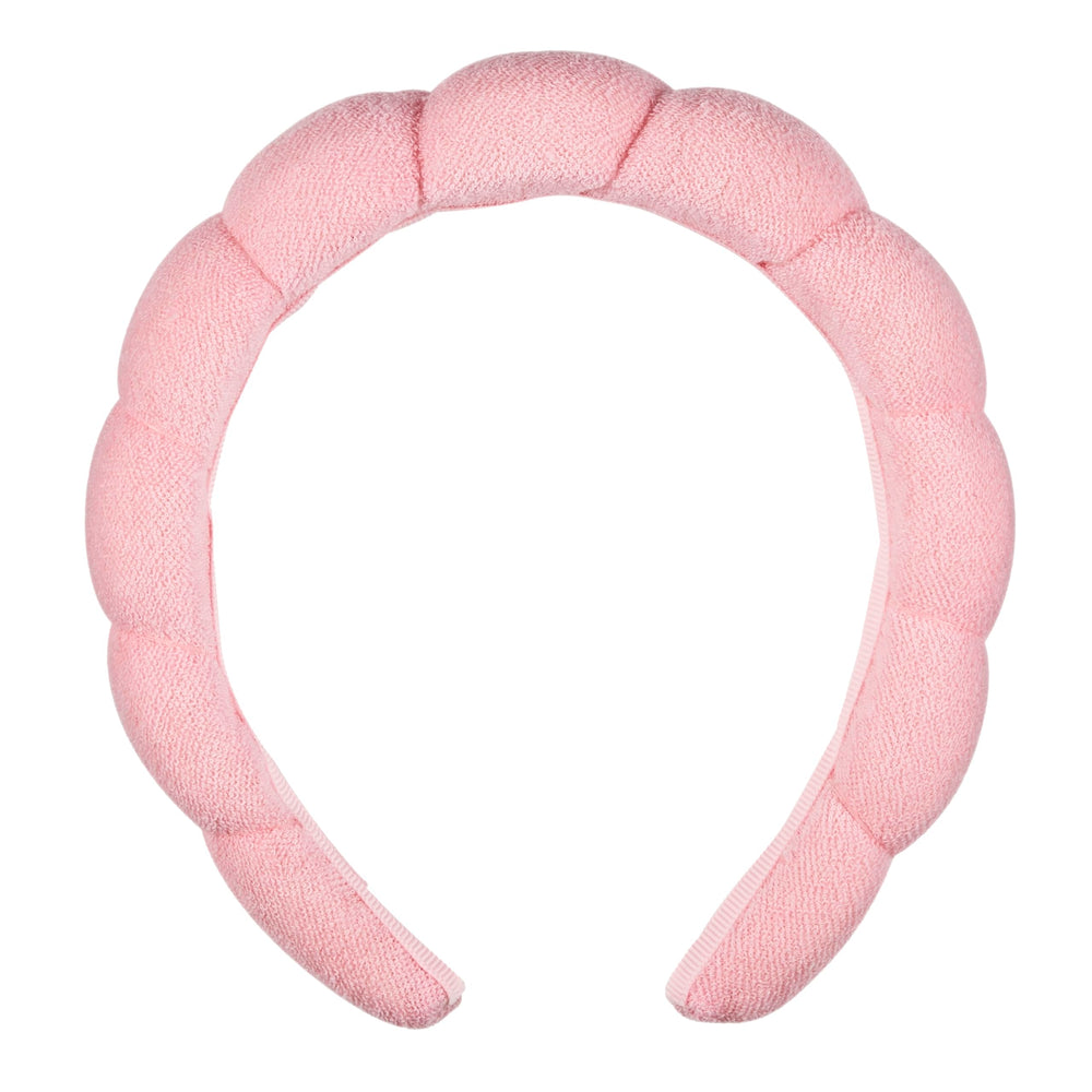Conair Spa headband with pink bubble design for makeup and facial cleansing.