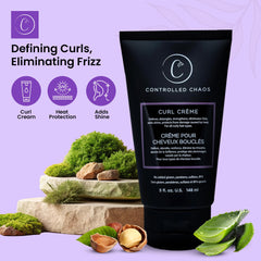 Hands applying Controlled Chaos Curl Cream to damp curls.