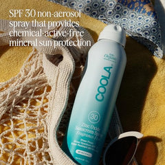 COOLA SPF 30 spray being applied by hand for quick, non-aerosol coverage