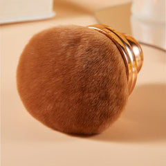 COSHINE brush with rounded handle for comfortable grip during makeup.