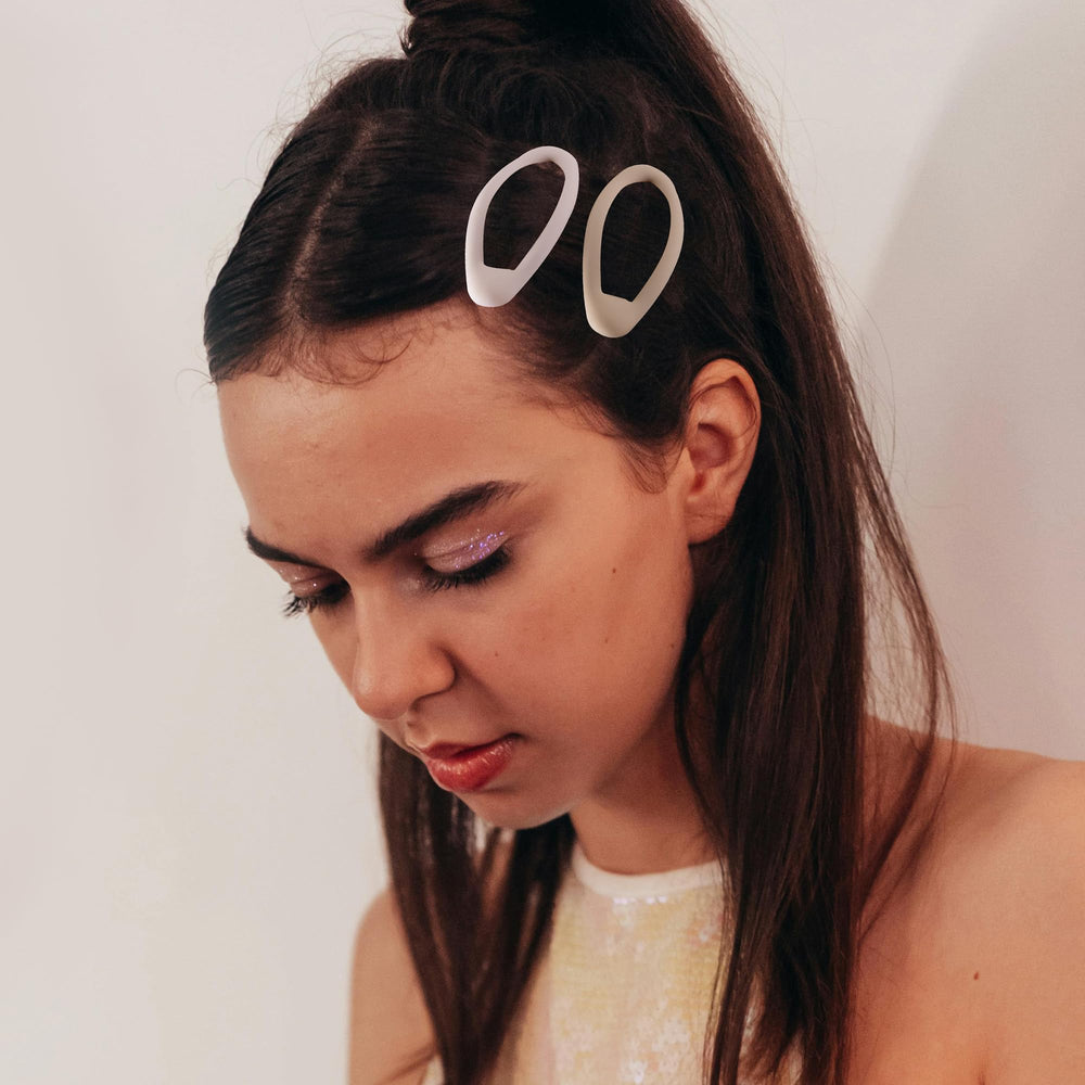 Cptots hair clip holding a ponytail for secure day styling.