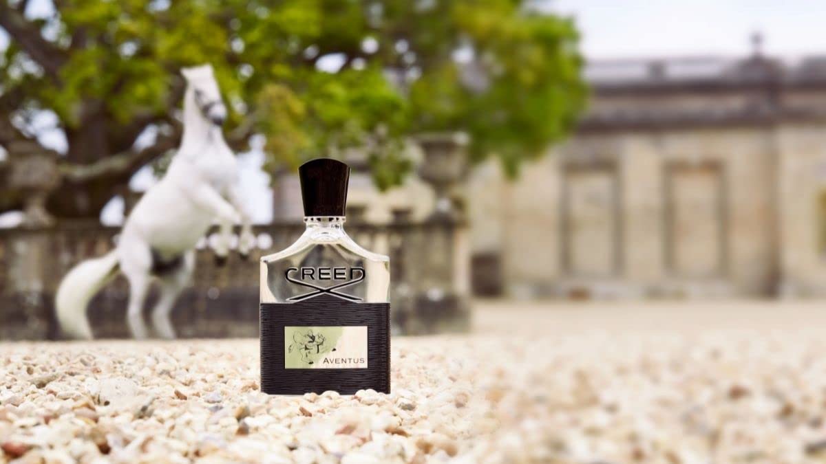 Creed Aventus label close-up emphasizing heritage and high-quality ingredients.