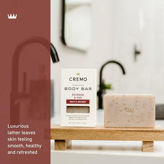 Cremo Bourbon & Oak exfoliating bar features shea butter for hydration.