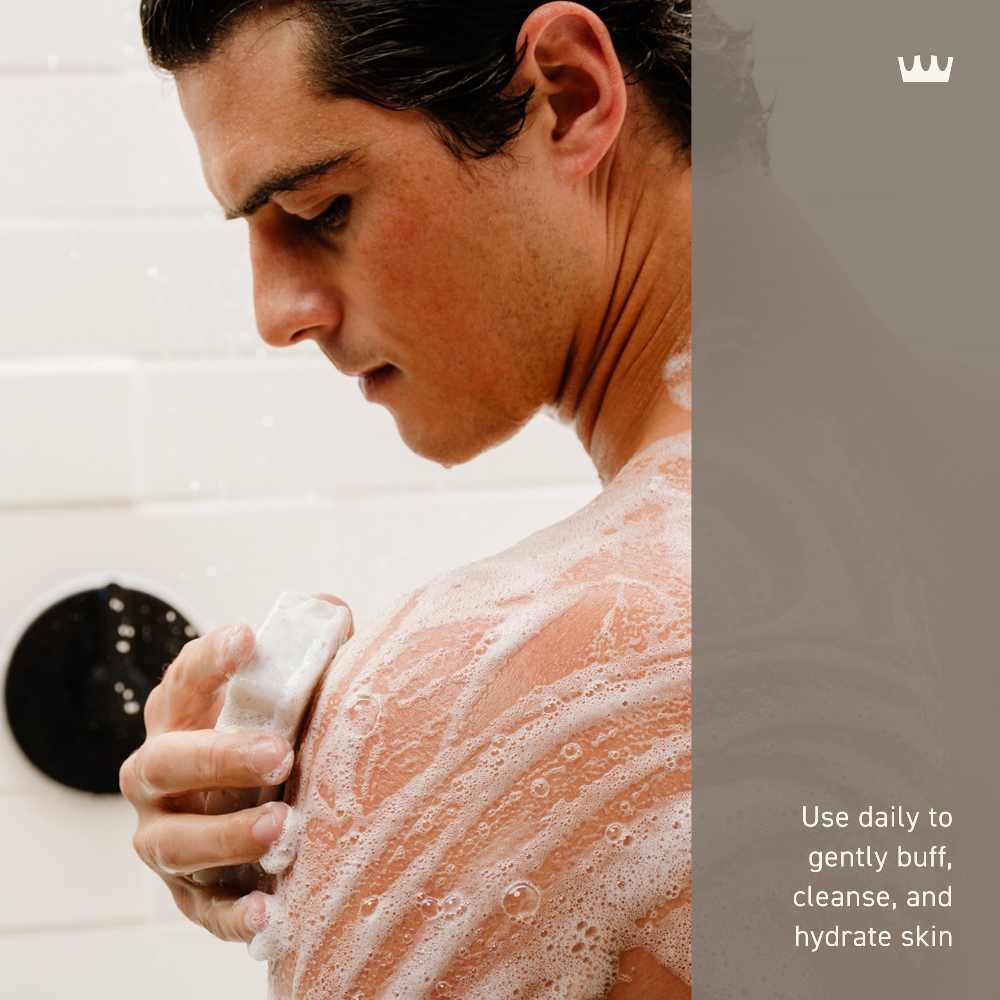 Cremo Vintage Suede body bar held in hand during shower ritual.