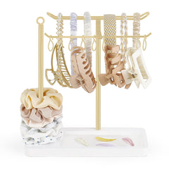 Dahey headband holder with gold base on a dresser showing organized storage