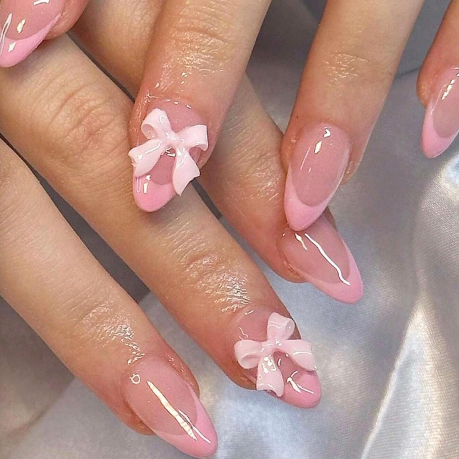 DAJIJIYOU 24-piece French tip nails with almond shape and bow charms for a quick manicure