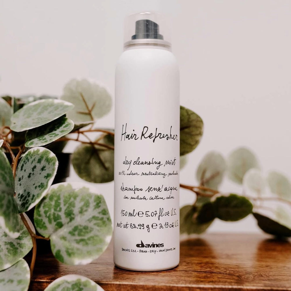 Davines Hair Refresher Dry Shampoo spray being applied to roots.