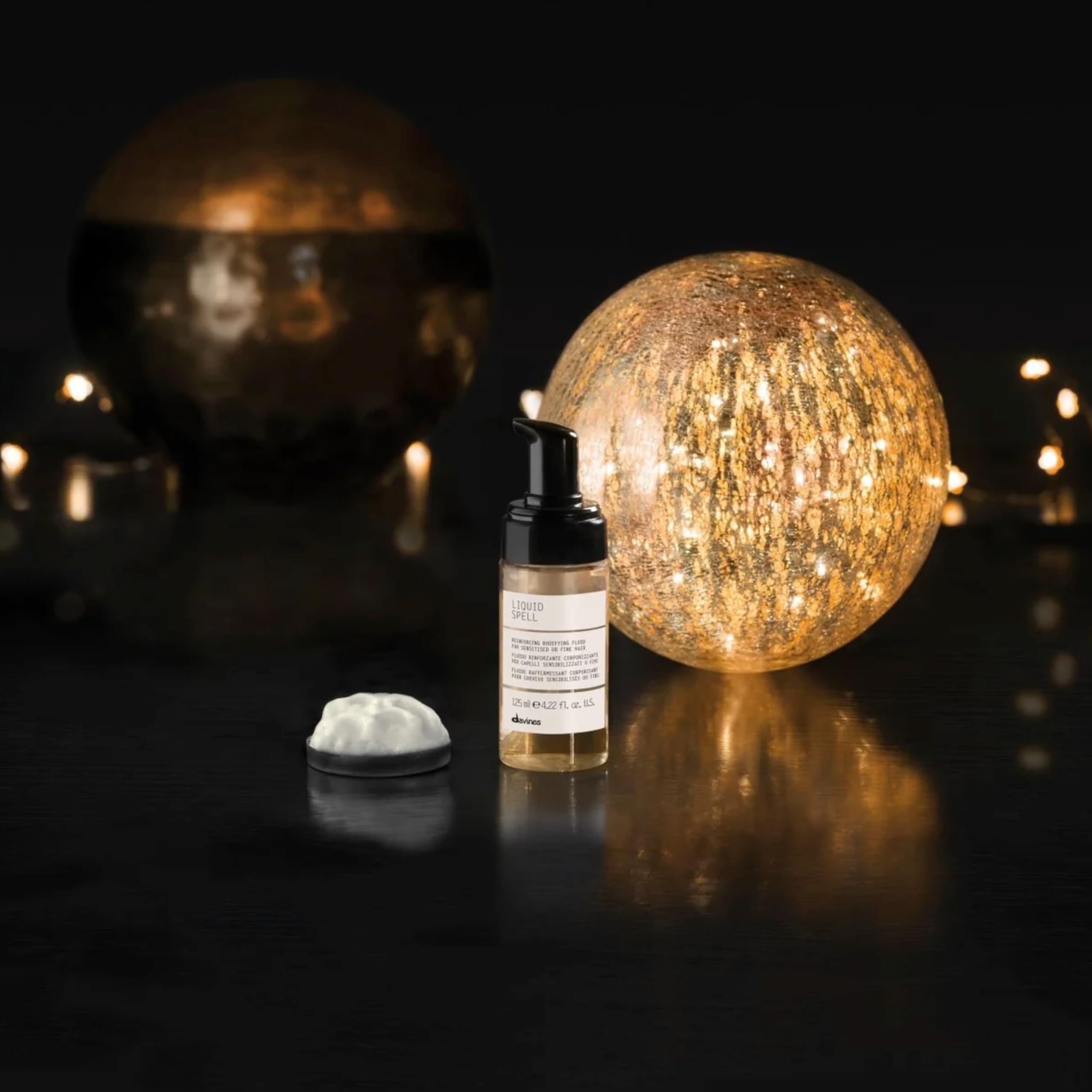 Close-up of Davines Liquid Spell bottle highlighting premium packaging.
