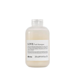 Davines LOVE Curl Shampoo bottle on bathroom shelf for curl definition.
