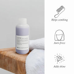 Close-up texture of Davines LOVE Hair Smoother Cream on hair for silkiness.