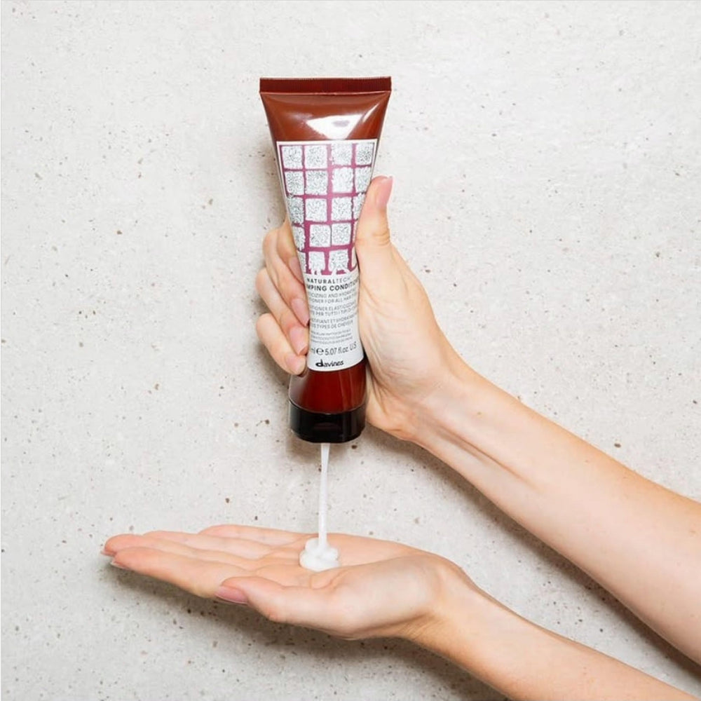 Texture swatch demonstrates rich, lightweight hydration from Davines Replumping Conditioner.