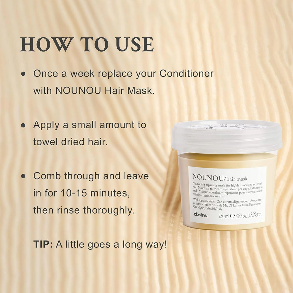 Creamy Davines Nounou Hair Mask texture shown during application on hair strands.