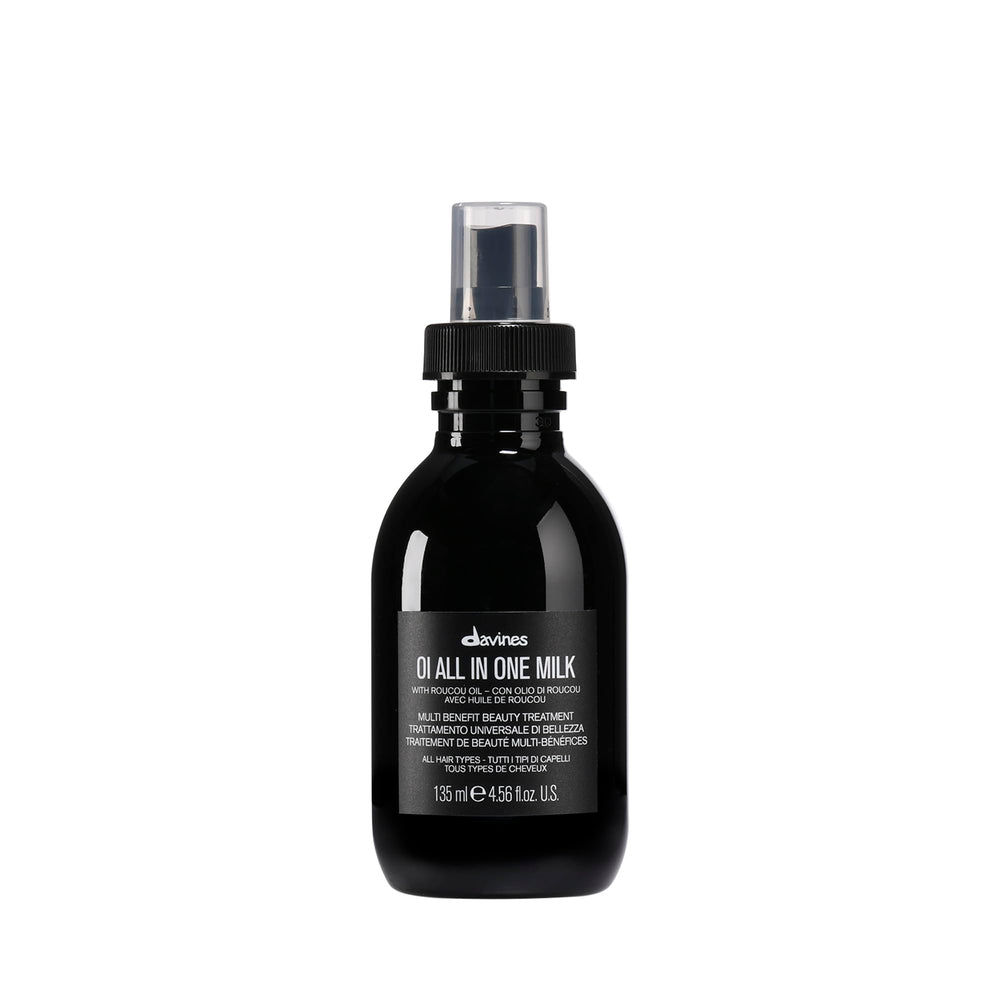 Davines OI All-In-One Milk bottle pour highlights easy detangling and shine.