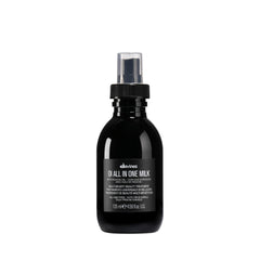 Davines OI All-In-One Milk bottle pour highlights easy detangling and shine.