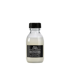 Davines OI Shampoo bottle pour showing milky texture for daily hydration